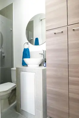 a bathroom with a sink and a toilet and a mirror at Cozy New Loft in Laureles / Estadio! in Medellín