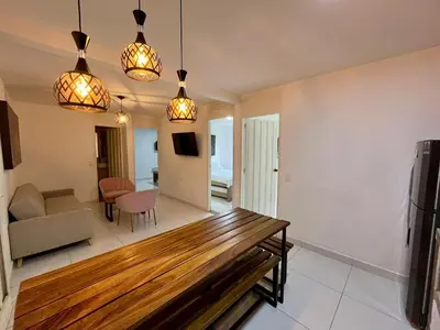 a living room with a couch and a table at Apartahotel Rosedal in Doradal