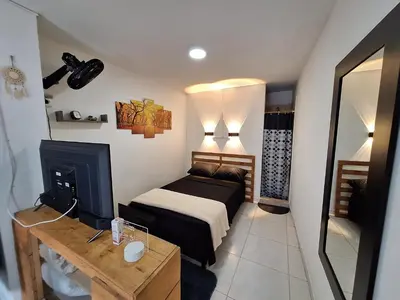 a small bedroom with a bed and a fireplace at OSIMiRI PLAZA Apartamento Naturaleza y aventura in San Rafael