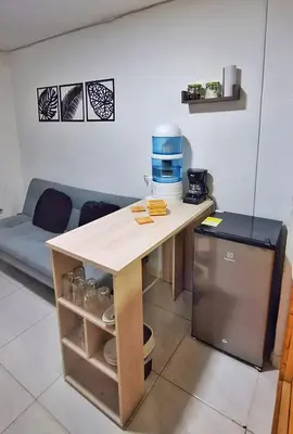 a kitchen with a table with a coffee maker on it at OSIMiRI PLAZA Apartamento Naturaleza y aventura in San Rafael