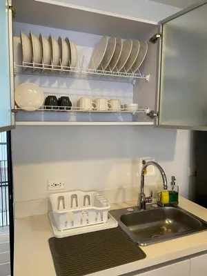 a kitchen counter with a sink and plates on a shelf at Apartamento Lauret en Laureles in Medellín