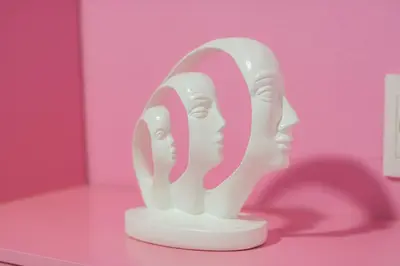 a white head statue sitting on top of a table at Hotel Chromatic in Guatapé