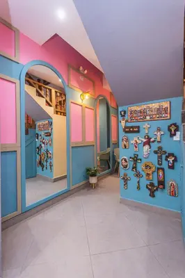a room with a wall of stickers on the wall at Hotel Chromatic in Guatapé