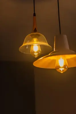 two lights are hanging from a ceiling at Hotel Chromatic in Guatapé