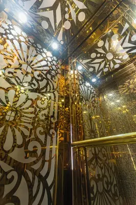 a room with a ceiling decorated with gold and black at Hotel Chromatic in Guatapé