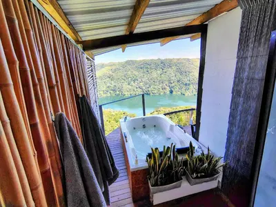 a bathroom with a tub and plants in a window at COCOZNA Glamping in Norcasia