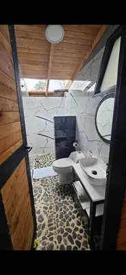 a bathroom with a toilet and a sink at Cabaña Starka & Jacuzzi in Marinilla