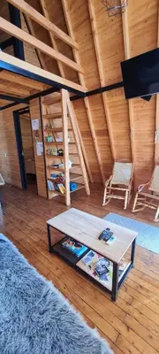 a living room with a table and two chairs at Cabaña Starka & Jacuzzi in Marinilla