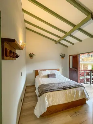 a bedroom with a bed in a room at Hotel Casa Dulces del Jardín in Jardin