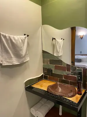 a bathroom with a sink and a mirror at Hotel Casa Dulces del Jardín in Jardin