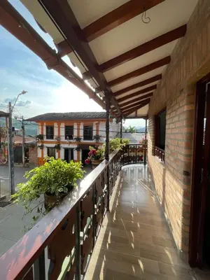 an outdoor balcony with awnings and plants on a building at Hotel Casa Dulces del Jardín in Jardin