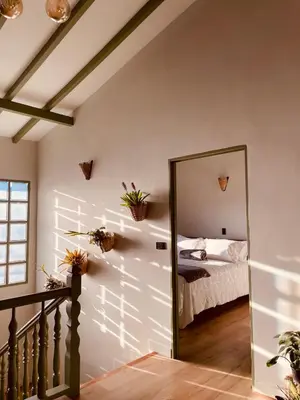 a bedroom with a mirror in front of a bed at Hotel Casa Dulces del Jardín in Jardin