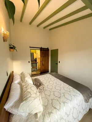 a bedroom with a large bed in a room at Hotel Casa Dulces del Jardín in Jardin