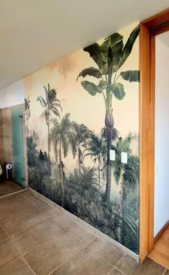 a mural of palm trees on a wall in a hallway at Double Master Provenza Penthouse, home gym&offices in Medellín