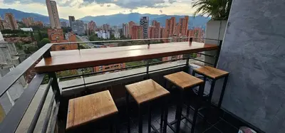 a balcony with four chairs and a table on a building at Double Master Provenza Penthouse, home gym&offices in Medellín