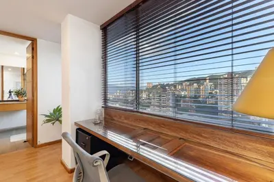 a room with a large window with a desk and a view at Double Master Provenza Penthouse, home gym&offices in Medellín