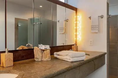 a bathroom with a counter with a mirror and a sink at Double Master Provenza Penthouse, home gym&offices in Medellín