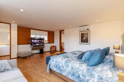 a bedroom with a bed with blue pillows at Double Master Provenza Penthouse, home gym&offices in Medellín