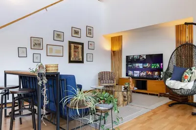 a living room with blue chairs and a table at Double Master Provenza Penthouse, home gym&offices in Medellín