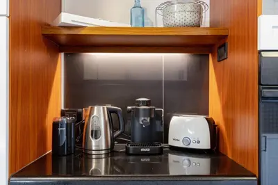 a kitchen counter with a coffee maker and a toaster at Double Master Provenza Penthouse, home gym&offices in Medellín