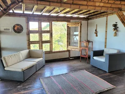 a living room with two couches and a rug at LA MARQUESA PACORA in Pácora
