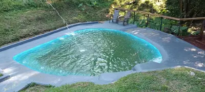 a small pool of water with a chair in it at Isla Escondida Maceo Finca Hotel y Restaurante in Yolombó