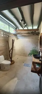 a bathroom with a toilet in the middle of a room at Isla Escondida Maceo Finca Hotel y Restaurante in Yolombó