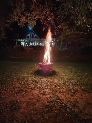 a pot of fire in a yard at night at Isla Escondida Maceo Finca Hotel y Restaurante in Yolombó