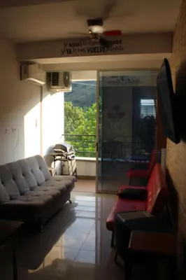 a living room with couches and a large window at Hakuna Matata in San Jerónimo