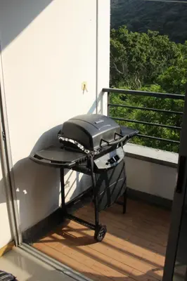a grill on a balcony with a view at Hakuna Matata in San Jerónimo