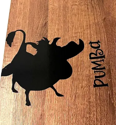 a black silhouette of a turkey on a wooden table at Hakuna Matata in San Jerónimo