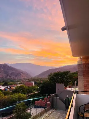 a view of the mountains at sunset from a balcony at ¡Vista Increíble Apartamento Tamarindo! in Santa Fe de Antioquia