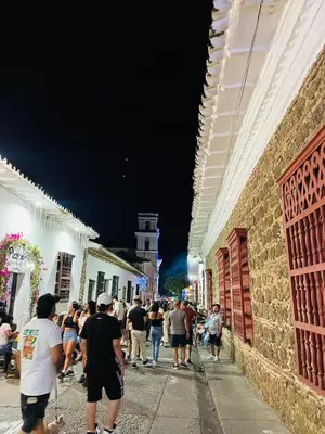 a group of people walking down a street at night at ¡Vista Increíble Apartamento Tamarindo! in Santa Fe de Antioquia