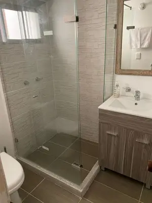 a bathroom with a shower with a sink and a toilet at APARTAMENTO LAURELES ESTADIO NUEVO in Medellín