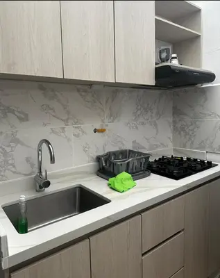 a kitchen counter with a sink and a stove at APARTAMENTO LAURELES ESTADIO NUEVO in Medellín