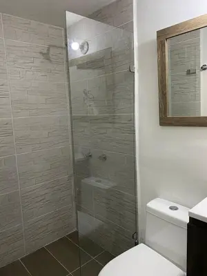 a bathroom with a glass shower with a toilet at APARTAMENTO LAURELES ESTADIO NUEVO in Medellín