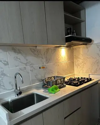 a kitchen with a sink and a stove at APARTAMENTO LAURELES ESTADIO NUEVO in Medellín