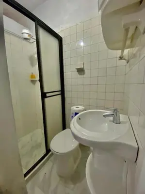 a bathroom with a toilet and a sink and a shower at Casa Laura in Medellín