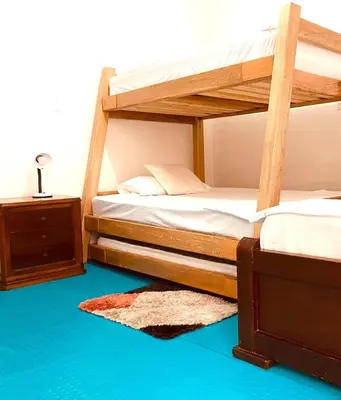 two bunk beds in a room with a blue floor at Casa Laura in Medellín
