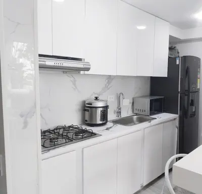 a white kitchen with a stove and a sink at Semi-loft Manizales Colombia in Manizales