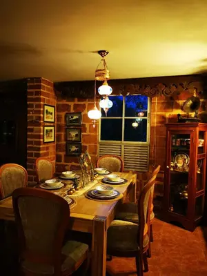 a dining room with a wooden table and chairs at Finca con forma de castillo y piscina en Sopetrán in Sopetran
