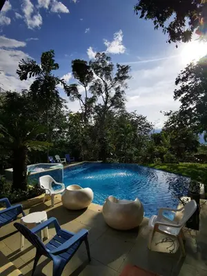 a swimming pool with lounge chairs at Finca con forma de castillo y piscina en Sopetrán in Sopetran