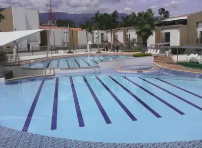 a large blue swimming pool in a hotel at Apartasol Ciudadela Santafe in Santa Fe de Antioquia