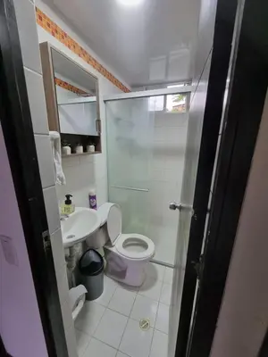 a bathroom with a toilet and a sink and a shower at Apartasol Ciudadela Santafe in Santa Fe de Antioquia