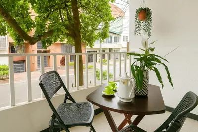 a table and chairs on a balcony with a table and a plant at loft cerca a laureles, WIFI, cerca metro y GUARDA EQUIPAJE GRATIS!! in Medellín