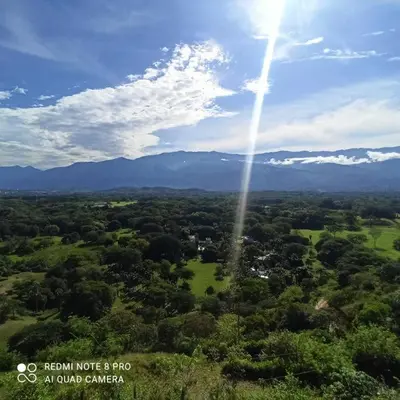 an aerial view of a field with the sun in the sky at Piscina-gran vista-clima cálido y pueblo histórico in Santa Fe de Antioquia