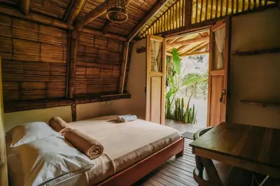 a bedroom with a bed in a room with a window at Pradera Ecoliving in Betania
