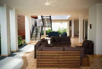 a living room with a couch and a staircase at Casa Amarilla in Honda
