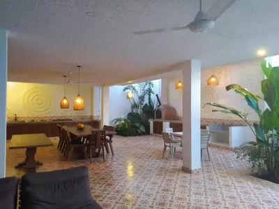 a living room with tables and chairs and a dining room at Casa Amarilla in Honda