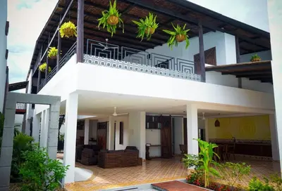 a house with a balcony with plants on it at Casa Amarilla in Honda